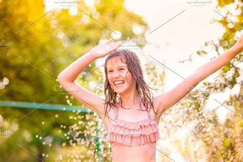 Girl In Bikini Dancing At The Sprinkler Summer Garden High Quality
