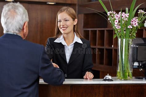 Receptionist Greeting Senior Guest With Handshake Stock Photos Image