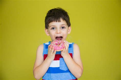 Boy In A Striped T Shirt Is About To Eat A Sweet Doughnut Stock Image
