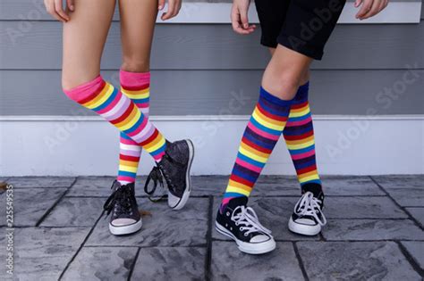 Tween Girls Legs With Colorful Striped Socks And Tennis Shoes Buy