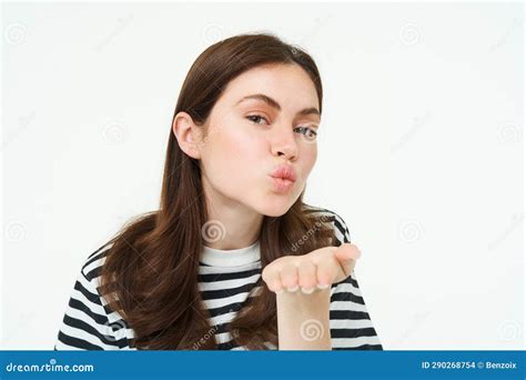 Portrait Of Cute Girl Sending You Blowing Air Kiss Holding Palm Near