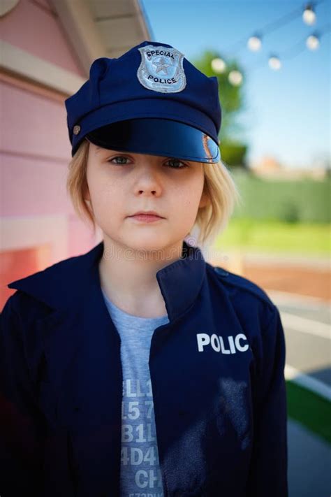 Portrait Of Handsome Boy A Kid In Police Uniform Having Fun On