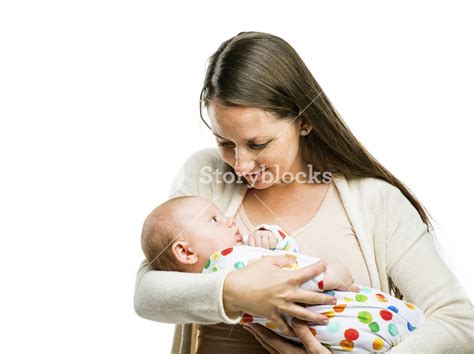 Smiling Mother Holding A Baby In Her Arms Isolated On White Background