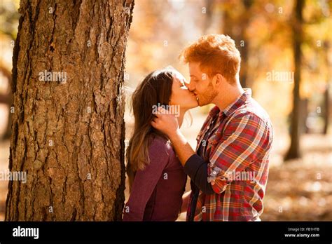 Romantic Young Couple Kissing In Autumn Forest Stock Photo Alamy