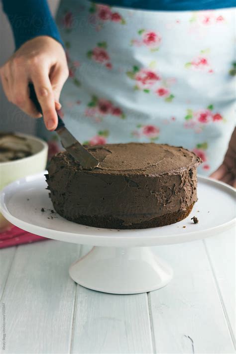 Woman Frosting A Chocolate Cake By Stocksy Contributor Kirsty Begg Stocksy