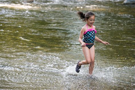 Little Girl Playing In A River By Stocksy Contributor Ronnie Comeau