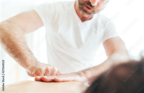 Bearded Masseur Man Doing Massage Manipulations On The Scapula Area Zone During Young Female