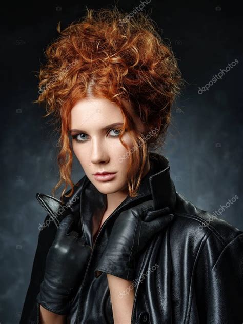 Portrait Of Red Haired Woman In A Leather Jacket On A Dark Backg
