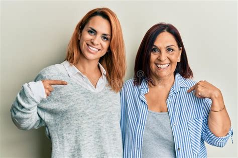 Latin Mother And Daughter Wearing Casual Clothes Pointing Finger To One Self Smiling Happy And