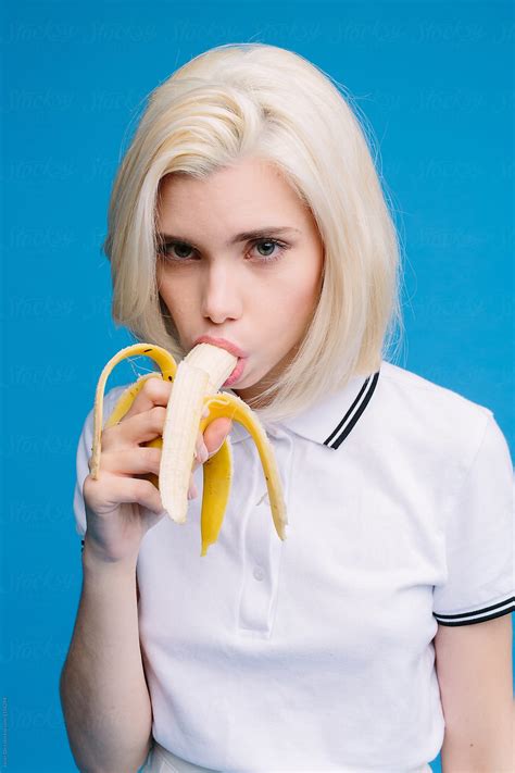 Attractive Blonde Girl Eating Banana Seductively By Javier Díez Stocksy United