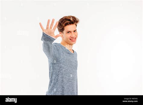 Smiling Young Guy Welcomes Saying Goodbye To Hand On White Background