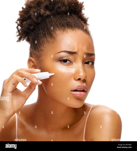 Scowling Girl Applying Treatment Cream Photo Of African American Girl On White Background Skin