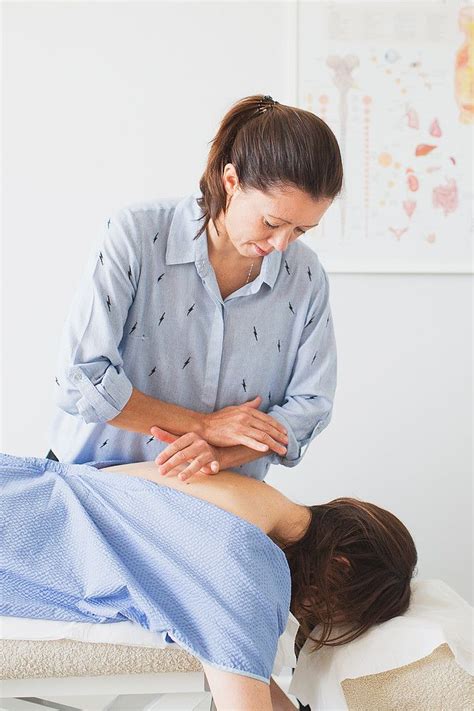 A Woman Getting A Back Massage From A Physcaron Nurse In A Room