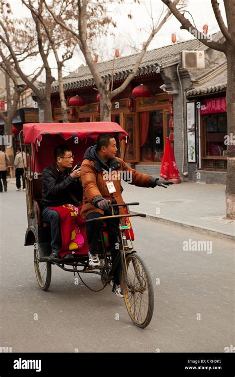 Rickshaw Driver Taking Tourist For Hutong Tour Beijing China Asia