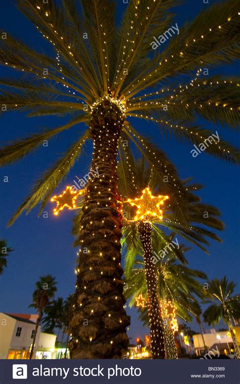 Beautiful multicolored building decorated with ornament, barcelona, spain. Palm trees decorated with Christmas lights in the Normandy ...
