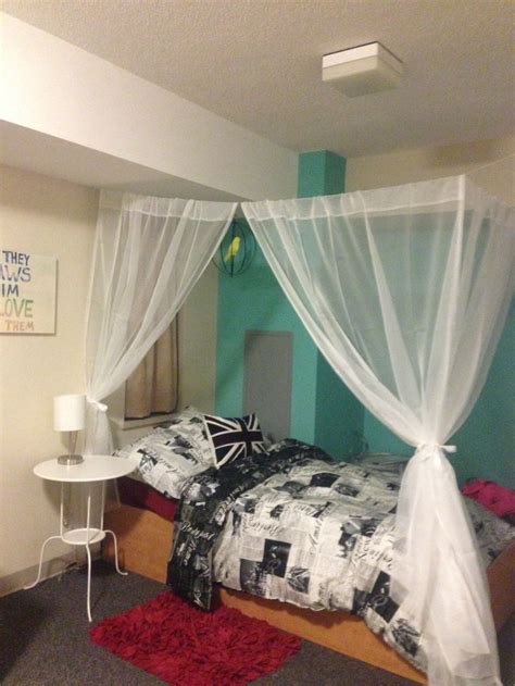 Dorm Room Decorating Canopy Made Using Sheer Curtains Held Up By String And Tied With Ribbons
