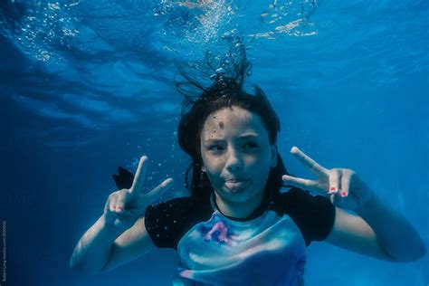 Young Preteen Girl Having Fun Swimming In A Pool Underwater By Stocksy Contributor Robert