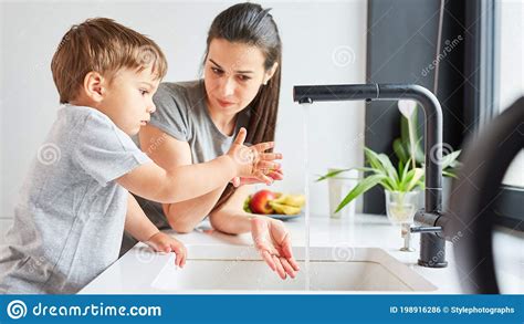 Child Learns To Wash Hands With Soap At The Sink Stock Photo Image Of