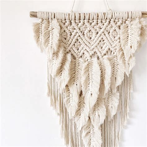 The macramé tutorial only uses four types of. Boho macrame feather wall hanging / modern macrame ...