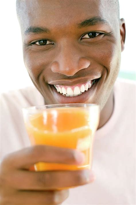 Man Drinking Orange Juice Photograph By Ian Hootonscience Photo