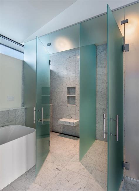 “it has frosted glass and two doors one to the toilet room and one to the shower with a green