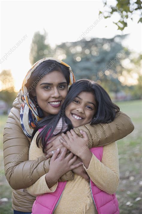 Portrait Muslim Mother In Hijab Hugging Daughter In Park Stock Image