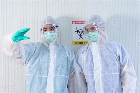 Two Asian Medical Staffs Wear Ppe Suit And Medical Gloves Showing