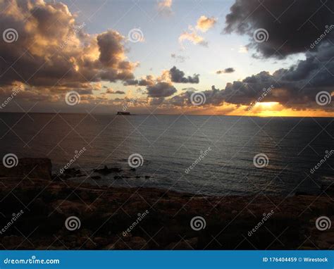 Breath Taking Sunset Over The Ocean With The Islet Of Filfla In Malta