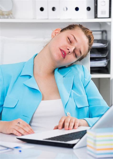 Woman Worker Is Sleeping At Work After Putting The Reports Stock Photo