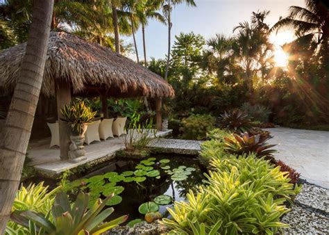 Tropical Landscape Design With A Water Feature Bridge And Hut Hgtv