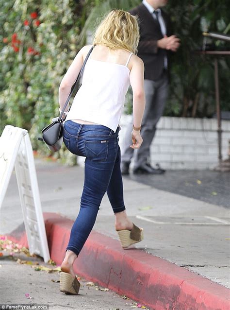 Elle Fanning In Skinny Jeans Cami Top And Wedges As She Breaks From