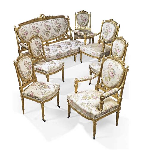 A French Giltwood And Silk Upholstered Seven Piece Salon Suite Of