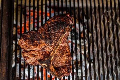 Grilling Big T Bone Steak On Natural Charcoal Barbecue Grill Stock