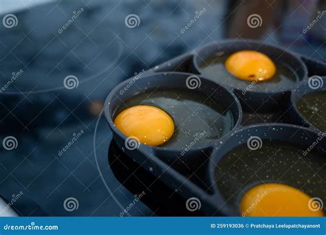 Make Fried Eggs on Black Frying Pan on Electric Stove for Breakfast