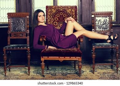 Beautiful Brunette Violet Gown Lying On Stock Photo