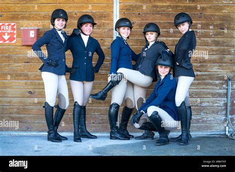 A Group Of Equestrian High School Girls Dressed In Show Clothes Are