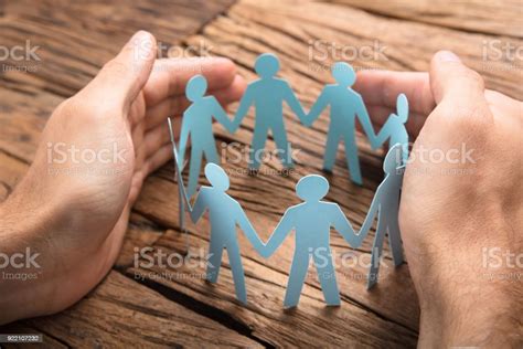 Businessmans Hands Covering Paper Team On Table Stock Photo Download