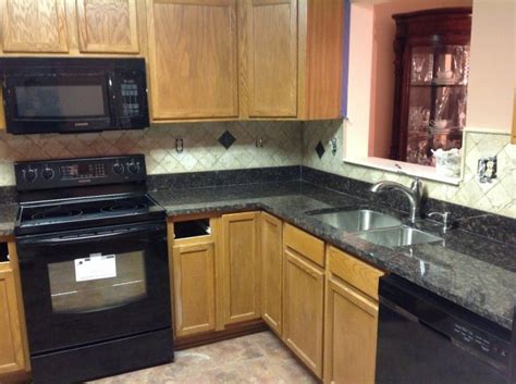 White cabinets, black counter, white penny tile backsplash: Kitchen:Quartz Countertops With Oak Cabinets Black ...