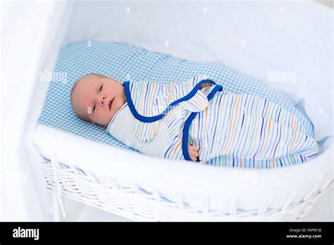 Adorable Newborn Baby Sleeping Swaddled In White Bed New Born Boy