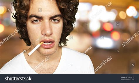 Portrait Of A Sad Smoker At A Crowded City Background Stock Photo