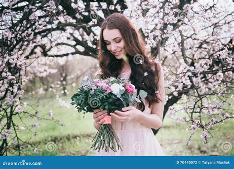 Woman In Blooming Trees Woman With Wedding Bouquet In Hands Stock
