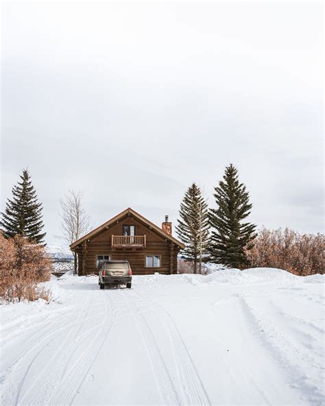 Brown Wooden House On Snow Covered Ground · Free Stock Photo