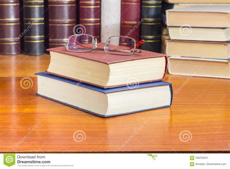 Eyeglasses On The Two Closed Books Against Of Other Books Stock Image Image Of Binding