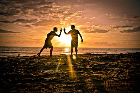 Silhouette Of Two Men On Beach During Sunset Hd Wallpaper Wallpaper Flare