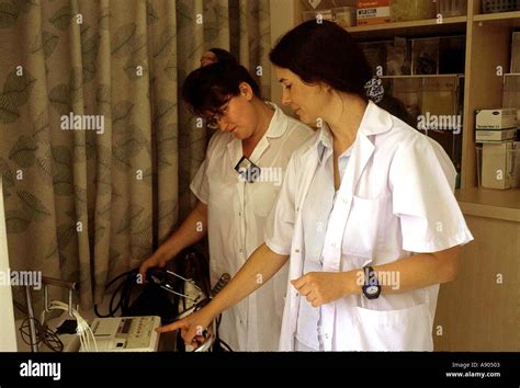 Two Female Nurses Discussing Patients Chart Stock Photo Alamy