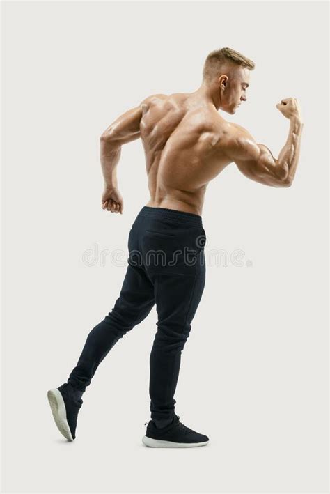 Strong Back Of A Athletic Muscular Man Flexing His Arms Stock Image