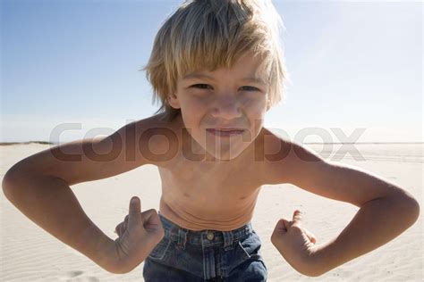 Boy Flexing Muscles On Beach Stock Image Colourbox