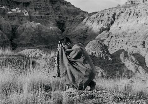 Male Kneeling With Blanket In High Desert By Stocksy Contributor