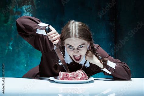 Bloody Halloween Theme Crazy Girl With A Knife Fork And Meat