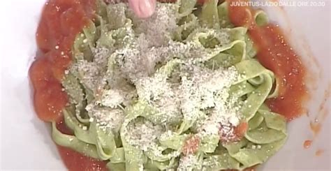 A White Plate Topped With Lettuce Covered In Sauce And Parmesan Cheese